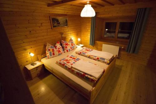 a bedroom with two beds in a wooden room at Ferienwohnung Krennbauer in Öblarn