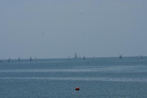 a large body of water with sailboats in the water at Hotel Marea in Grado