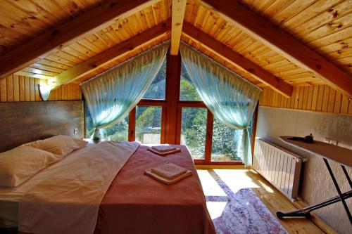 a large bed in a room with a large window at Ayder İmamoğlu Apart Otel in Ayder Yaylasi