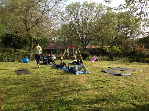 a group of people laying on the grass in a park at Agriturismo Pranu in Sorgono