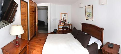 Ένα ή περισσότερα κρεβάτια σε δωμάτιο στο Hotel Galerias Pasto