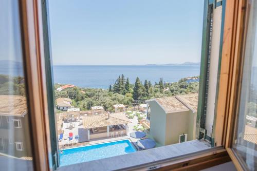 a view of a swimming pool from a window at Corfu Aqua Nisaki in Nisakion