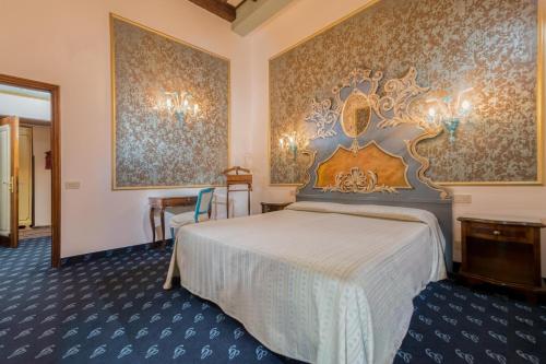 a hotel room with a bed and a wall at Hotel Giorgione in Venice