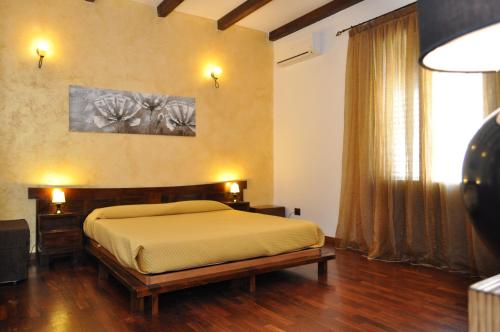 a bedroom with a bed and a large window at Rooms and Breakfast Zefiro in San Vito lo Capo