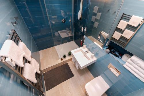 an overhead view of a bathroom with a sink and a shower at LUXURY Apartment Dlouha in Prague