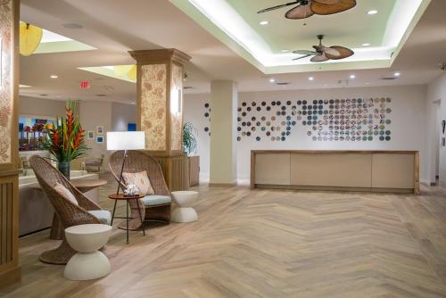 a lobby with a waiting area with chairs and a ceiling at Hawks Cay Resort in Marathon