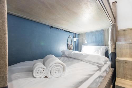a bedroom with a bed with towels on it at Mimi and Jim Co-living space in Cha Am