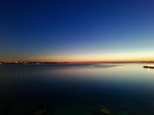 a view of a large body of water at night at Hostal Casa Aurita Adults Only in Sanxenxo