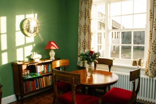 a green room with a table and chairs and a window at Elizabeth Fort in Cork