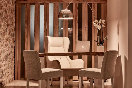 a salon with chairs and a table with a laptop at 100 Rizes Seaside Resort- Small Luxury Hotels of the World in Gythio