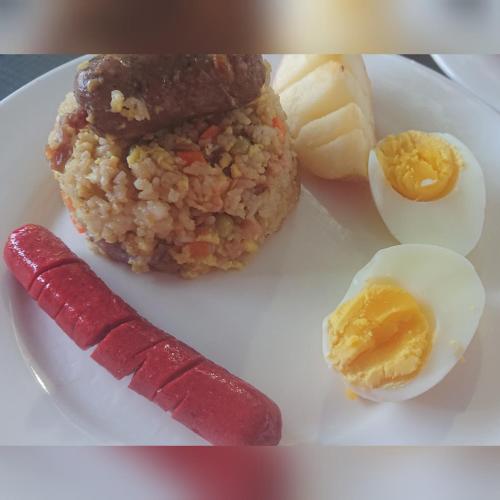 a plate of food with an egg and a knife at Prince Transient house in San Jose