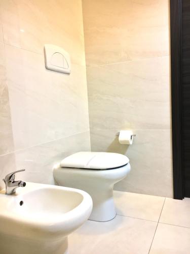 a bathroom with a toilet and a sink at B&B Costa Azzurra in Porto Cesareo