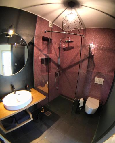 a bathroom with a shower and a sink and a toilet at Apartma Vita in Dobrovo