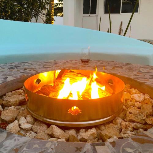 a fire pit on a table with flames in it at Playa 55 beach escape - adults only Guesthouse in Celestún