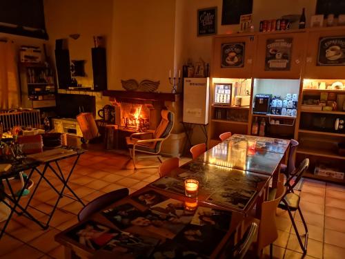 a living room with a fire place and a fireplace at Au Nid de Tillé in Tillé