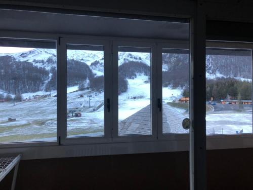 a view of a snowy mountain from a window at APPARTAMENTO SAN NICOLA 2 in San Massimo