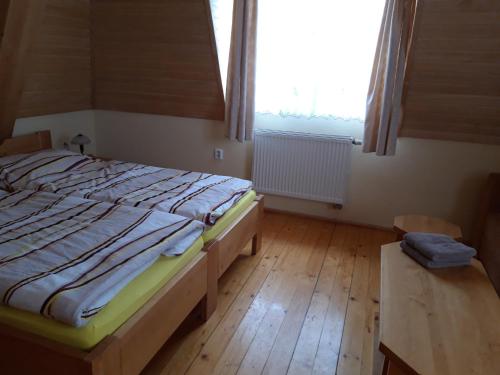 a bedroom with a large bed and a window at Penzión Weinerovka Varín in Žilina