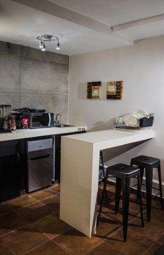 a kitchen with a counter and some stools in it at HOTEL CAREYES in Coatzacoalcos
