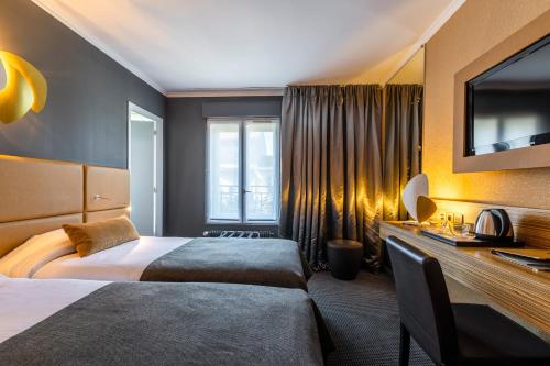 a hotel room with two beds and a television at Hotel Residence Europe & Spa in Clichy