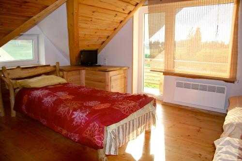 a bedroom with a bed and a desk and a window at Kaldavere Tourism Farm in Korkuna