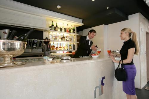 a man and a woman standing at a bar at Hotel Fiera Di Brescia in Brescia