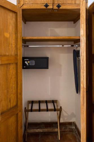 a wooden cabinet with a bench in a room at Puerta San Pedro in Guadalajara