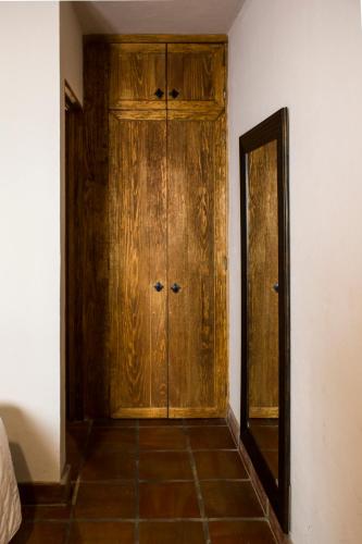 a wooden door in a room with a mirror at Puerta San Pedro in Guadalajara
