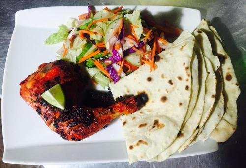 a plate of food with a taco and a salad at Silaa Cabana in Trincomalee