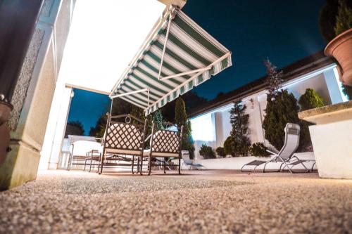 a group of chairs sitting outside of a building at Villa Dedinje in Belgrade