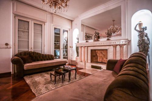 a living room with a couch and a fireplace at Villa Dedinje in Belgrade