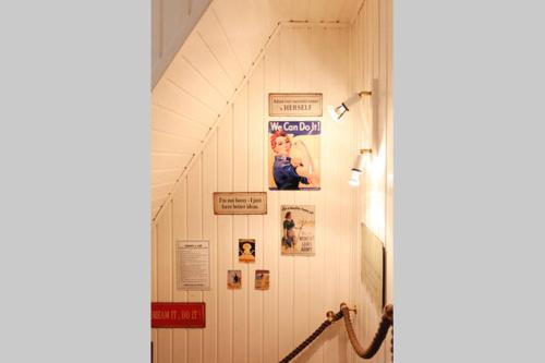 a hallway with a wall with posters and pictures on it at Hestavin Bed & Breakfast in Grünberg