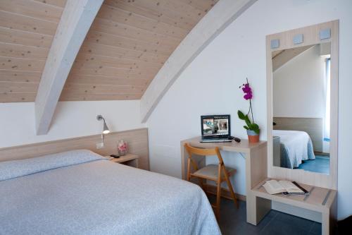 Postel nebo postele na pokoji v ubytování Hotel Norma