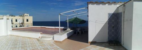 a balcony with an umbrella on top of a building at Terrazzo 73 in Ischia