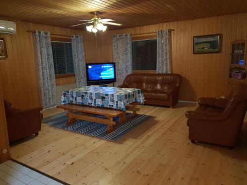 a living room with a couch and a coffee table at Järvitalo in Soini