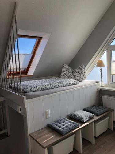 a room with a bed and stairs with a window at Gemütliche Ferienwohnung im Luftkurort in Albersdorf