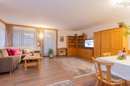 a living room with a couch and a table at Ferienwohnungen Christine in Waidring