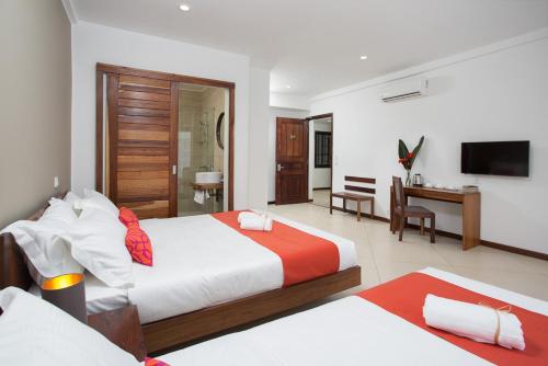 Postel nebo postele na pokoji v ubytování Tsanga Tsanga Hotel