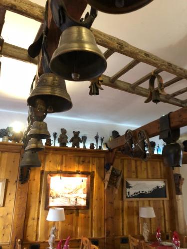 a group of bells hanging from the ceiling of a room at Hôtel Restaurant de la Chaussée in Briançon