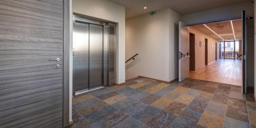 an office hallway with doors and a tile floor at Park Hotel & Residence by The Cube in Fidenza