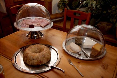 a table with two plates of food and a doughnut at Hôtel Restaurant de la Chaussée in Briançon