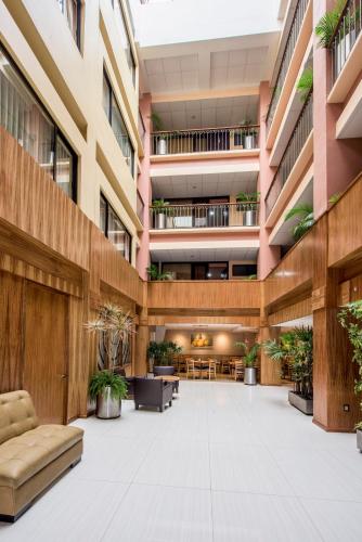 an empty lobby of a building with plants at Oaxaca Inn Reforma in Oaxaca City