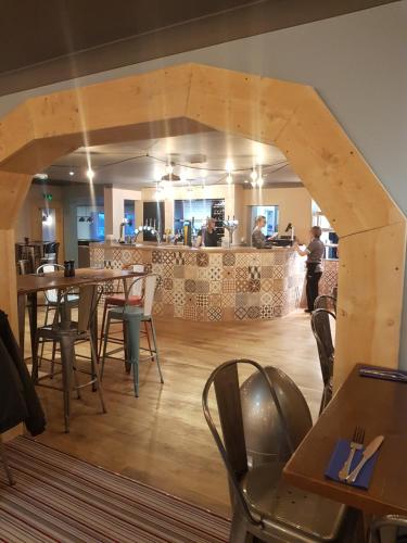 a restaurant with tables and chairs and a counter at 3 bedroom caravan with hot tub Tattershall lakes in Tattershall