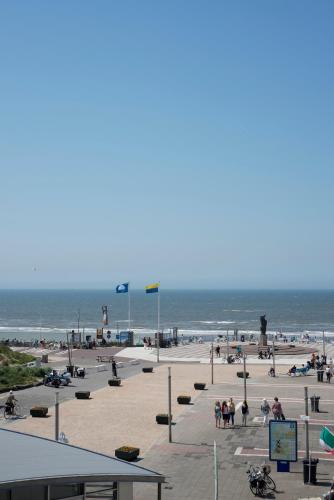 a group of people on a beach near the ocean at Amsterdam Beach Hotel in Zandvoort