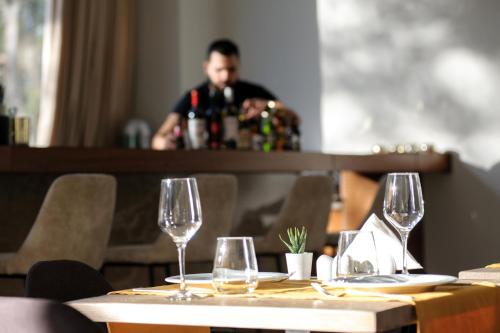 a table in a restaurant with wine glasses on it at B4B Athens Signature Hotel in Athens