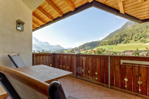 a balcony with a table and a view of mountains at Gasserhof in Barbiano