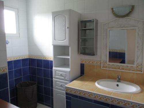 a bathroom with a sink and a mirror at Logement Soulac sur mer in Soulac-sur-Mer