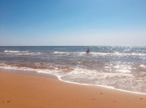 a person is in the water at the beach at Family Studios in Marathias