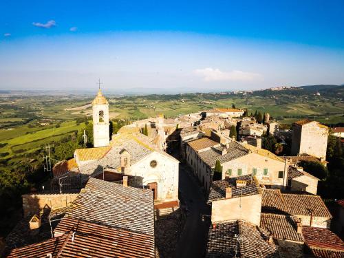 an aerial view of a village with a clock tower at LaChiusa Tuscany in Montefollonico