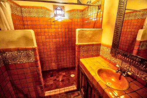 a bathroom with a sink and a mirror at Hotel Casa Encantada in Pátzcuaro
