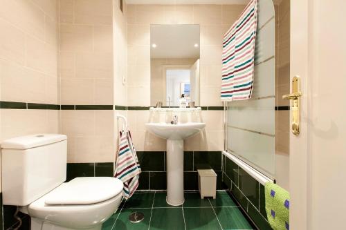 a bathroom with a toilet and a sink at Ribera in Madrid